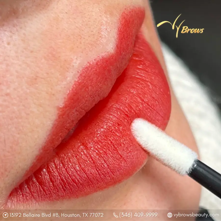 Lip blush pigment being applied during a session